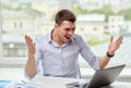 Angry businessman with laptop and papers in office Royalty Free Stock Photo