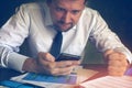 Angry businessman reading message in a smartphone. Royalty Free Stock Photo