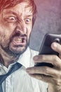 Angry businessman received frustrating SMS message Royalty Free Stock Photo