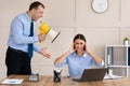 Angry Businessman Shouting At Female Employee Holding Megaphone In Office Royalty Free Stock Photo