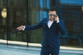 Angry businessman in sunglasses is talking by cellphone Royalty Free Stock Photo