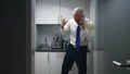 Angry businessman talking on smartphone standing in small office kitchen Royalty Free Stock Photo
