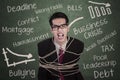 Angry businessman tied with rope in class