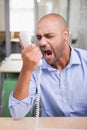 Angry businessman using telephone Royalty Free Stock Photo