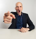 Angry businessman yells and pointing his finger at you Royalty Free Stock Photo