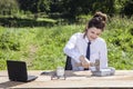 Angry businesswoman destroys the phone with a hammer