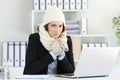 Angry businesswoman having cold at office