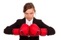 Angry businesswoman punching red boxing gloves together ready to Royalty Free Stock Photo