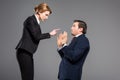 angry businesswoman quarreling and pointing at scared businessman Royalty Free Stock Photo