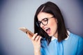 Angry businesswoman shouting on smartphone