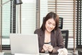 Angry businesswoman sitting with crumpled paper balls at desk Royalty Free Stock Photo