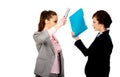 Angry businesswomen fighting with their binders. Royalty Free Stock Photo