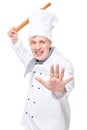 an angry chef with a wooden rolling pin attack on a white Royalty Free Stock Photo