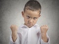 Angry child, boy with fist up in air, off