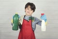 Angry child with cleaning products