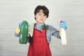 Angry child with cleaning products