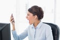 Angry classy brown haired businesswoman shouting at her mobile phone