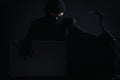 Angry computer hacker in suit stealing data from laptop with cro Royalty Free Stock Photo