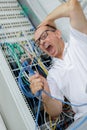 angry and confused man using wrong cables Royalty Free Stock Photo