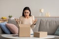 Angry confused woman unpacking parcel, wrong or broken online store order