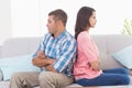 Angry couple with arms crossed sitting on sofa Royalty Free Stock Photo