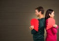 Angry couple holding broken heart Royalty Free Stock Photo