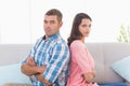 Angry couple sitting arms crossed on sofa Royalty Free Stock Photo