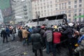 Angry crowd on the occupying street overturned burned-out bus on the demostration during anti-government protest Euromaidan