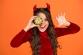 Angry devil teenage girl with pumpkin vegetable wear horns costume of imp on halloween party, happy halloween Royalty Free Stock Photo