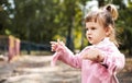 Angry displeased and distressed little girl, the child looks furious and upset. active holidays in autumn Royalty Free Stock Photo