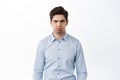 Angry and displeased office worker, frowning and looking mad, standing bothered or insulted, losing temper, boiling from