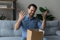 Angry dissatisfied customer receiving wrong parcel from internet store Royalty Free Stock Photo