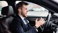 Angry young businessman driving alone in his new car Royalty Free Stock Photo