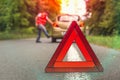 Angry driver kicking the tires on broken car Royalty Free Stock Photo