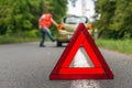 Angry driver kicking the tires on broken car Royalty Free Stock Photo