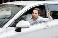 Angry driver stuck in traffic jam gesticulates with hand and screaming Royalty Free Stock Photo