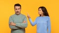 Angry european senior woman appears to be scolding a man who listens with a skeptical expression Royalty Free Stock Photo