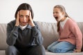 Angry excited aggressive teenager european girl yelling at sad tired millennial woman in living room Royalty Free Stock Photo