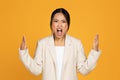 Angry excited crazy sad young asian woman in suit screaming, freaking out Royalty Free Stock Photo