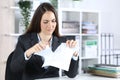 Angry executive woman ripping contract at office