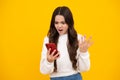 Angry face, upset emotions of teenager girl. Teenager child using mobile phone, chatting on web. Mobile app for Royalty Free Stock Photo
