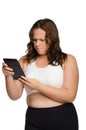 Angry fat athletic woman with tablet