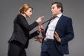 angry female boss pointing at businessman in formal wear Royalty Free Stock Photo