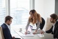 Angry female client pointing at mistake in business document