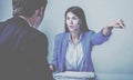 Angry female HR representative pointing at door, asking male job candidate to leave, making gesture sign Royalty Free Stock Photo