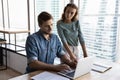 Angry female team leader looking with demand on incompetent employee.