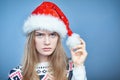 Closeup of Angry frowning woman wearing Santa hat