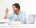 Angry, frustrated business man scream into phone in studio for fail, problem or debt stress at his desk. Rude, chaos and
