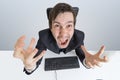 Angry and frustrated man is working with computer and shouting Royalty Free Stock Photo