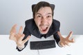 Angry and frustrated man is working with computer and shouting Royalty Free Stock Photo